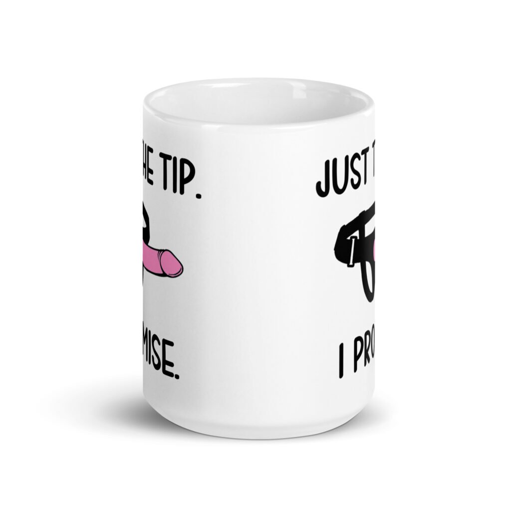White ceramic coffee mug that has an image of a strap-on dildo and the words 'Just the tip. I promise.' printed on both sides.