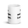 White ceramic mug with the pun phrase 'I'm a social vegan. I avoid meet.' printed on both sides.