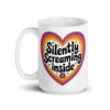 White ceramic coffee mug with a colorful graphic that says 'Silently screaming inside'. The graphics are printed on both sides of the mug.