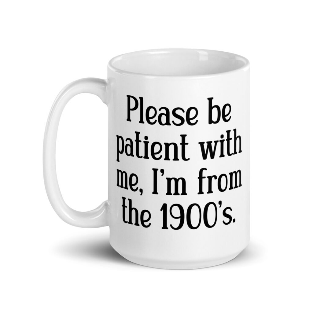 White ceramic mug with the text 'Please be patient with me, I'm from the 1900's' printed on both sides.