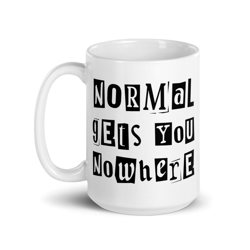 White ceramic coffee mug with the phrase 'Normal gets you nowhere' printed on both sides.