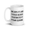 White ceramic mug with the phrase 'Some days it's hard to focus because I'm distracted by my own cleavage' printed on both sides.