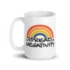 White ceramic coffee mug with a graphic of a rainbow and the words 'Spread negativity' printed on both sides.