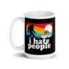 White coffee mug with graphic of Bigfoot walking into the sunset with the text 'I hate people' printed on both sides.
