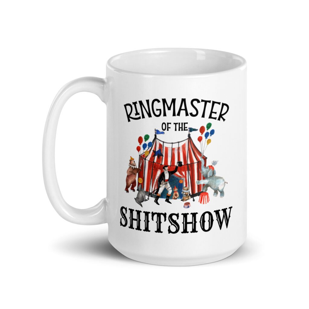 White ceramic coffee mug with a circus theme graphic and the text 'Ringmaster of the Shitshow' printed on both sides.