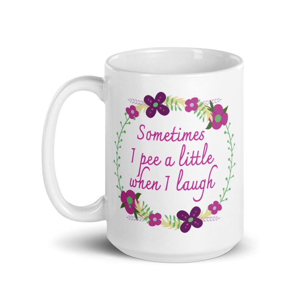 White ceramic coffee mug that has a colorful minimalistic style line drawing floral wreath with the text 'Sometimes I pee a little when I laugh' printed in the center of the wreath. The graphics are printed on both sides of the mug.