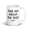White ceramic mug with the text 'Ask me about my tiny penis' printed on both sides. The word tiny is much smaller than the rest of the text.