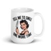 White ceramic mug with graphic of a woman holding a knife and the phrase 'Tell me to smile one more time' printed on both sides.