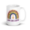 White ceramic mug with an image of a boho style rainbow. There is an upside down cross in the center arch of the rainbow and the text 'Love like Lucifer' printed under. The graphics are printed on both sides of the mug.
