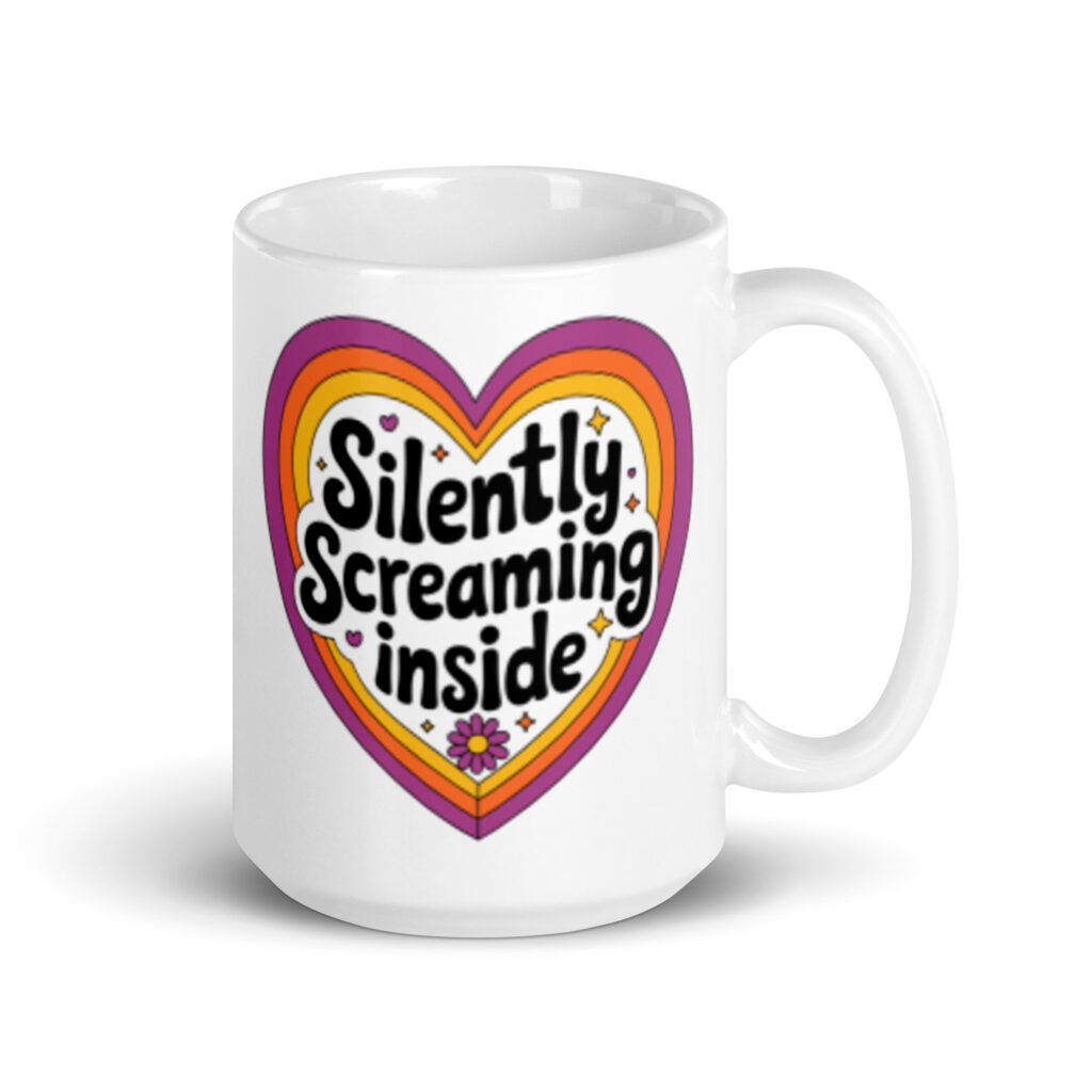 White ceramic coffee mug with a colorful graphic that says 'Silently screaming inside'. The graphics are printed on both sides of the mug.