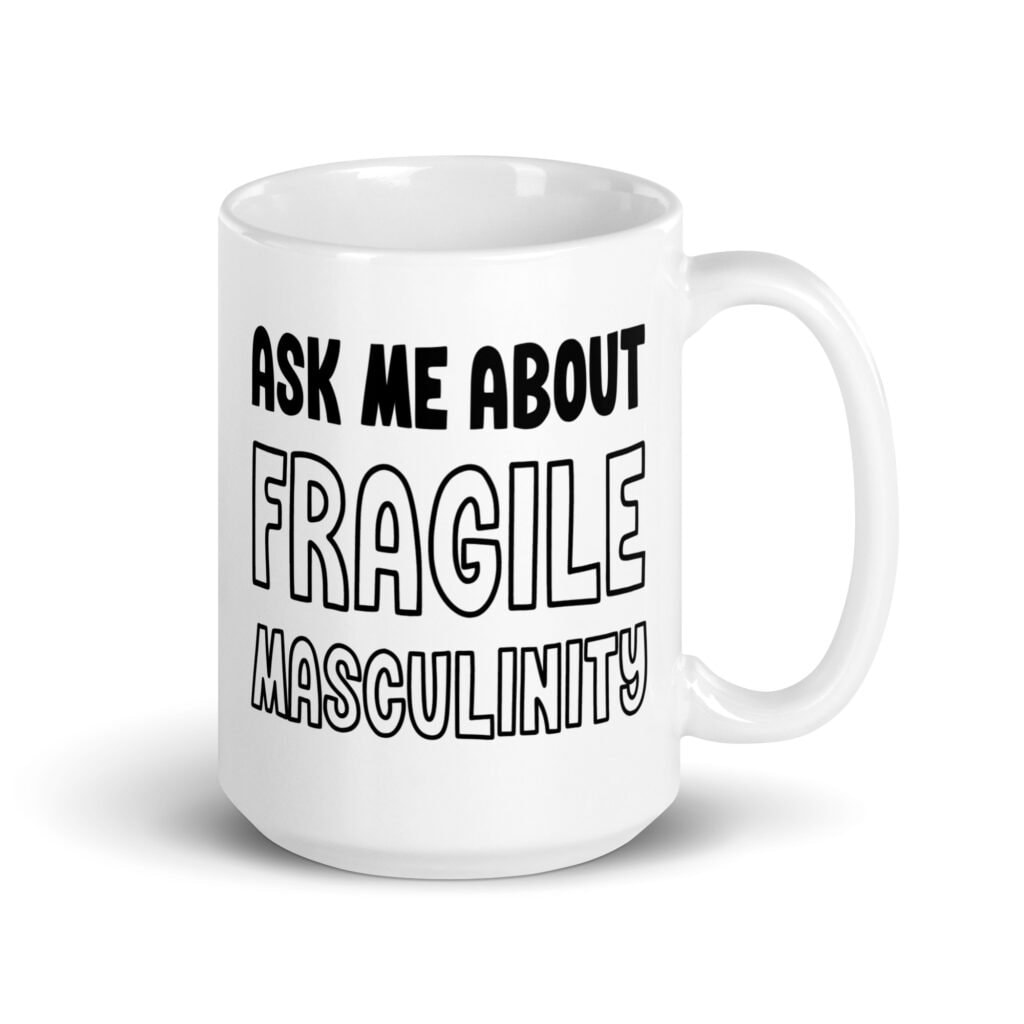 White ceramic coffee mug with the text 'Ask me about fragile masculinity' printed on both sides.