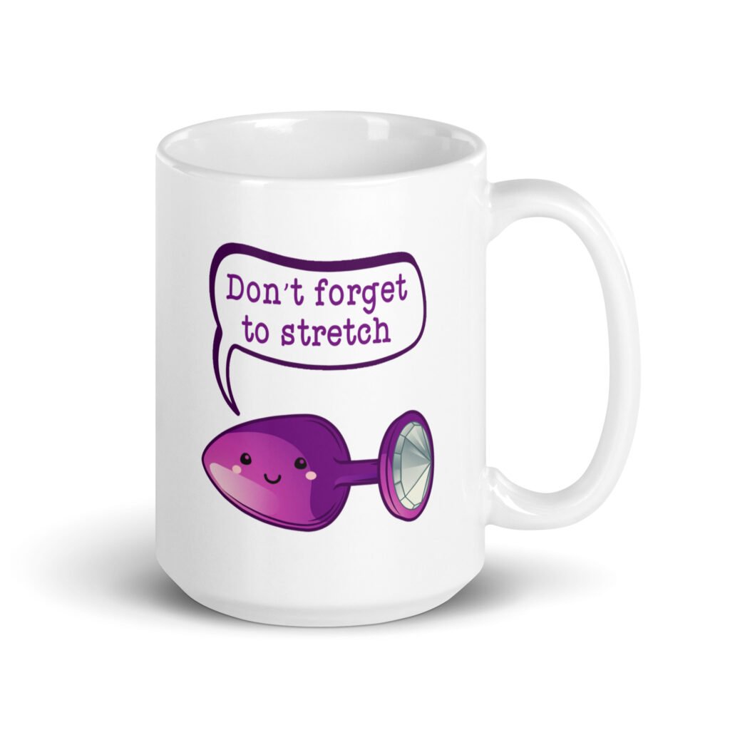 White ceramic coffee mug that has image of a purple anal plug with a smile face. There is a speech bubble above with the words 'Don't forget to stretch'. The graphics are printed on both sides of the mug.