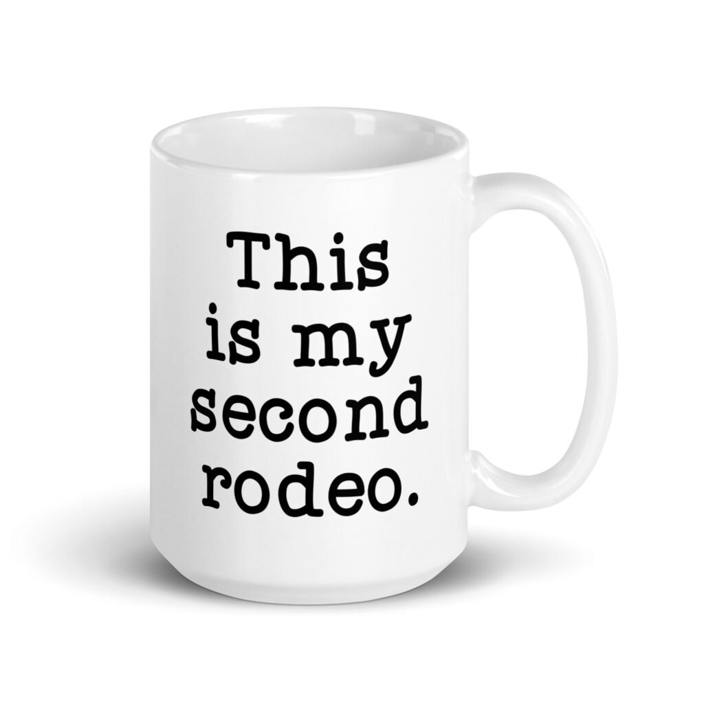 White ceramic mug with the text 'This is my second rodeo.' printed on both sides of the mug.