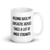 White ceramic mug with the phrase 'Holding back my sarcastic replies takes a lot of inner strength' printed on both sides of the mug.