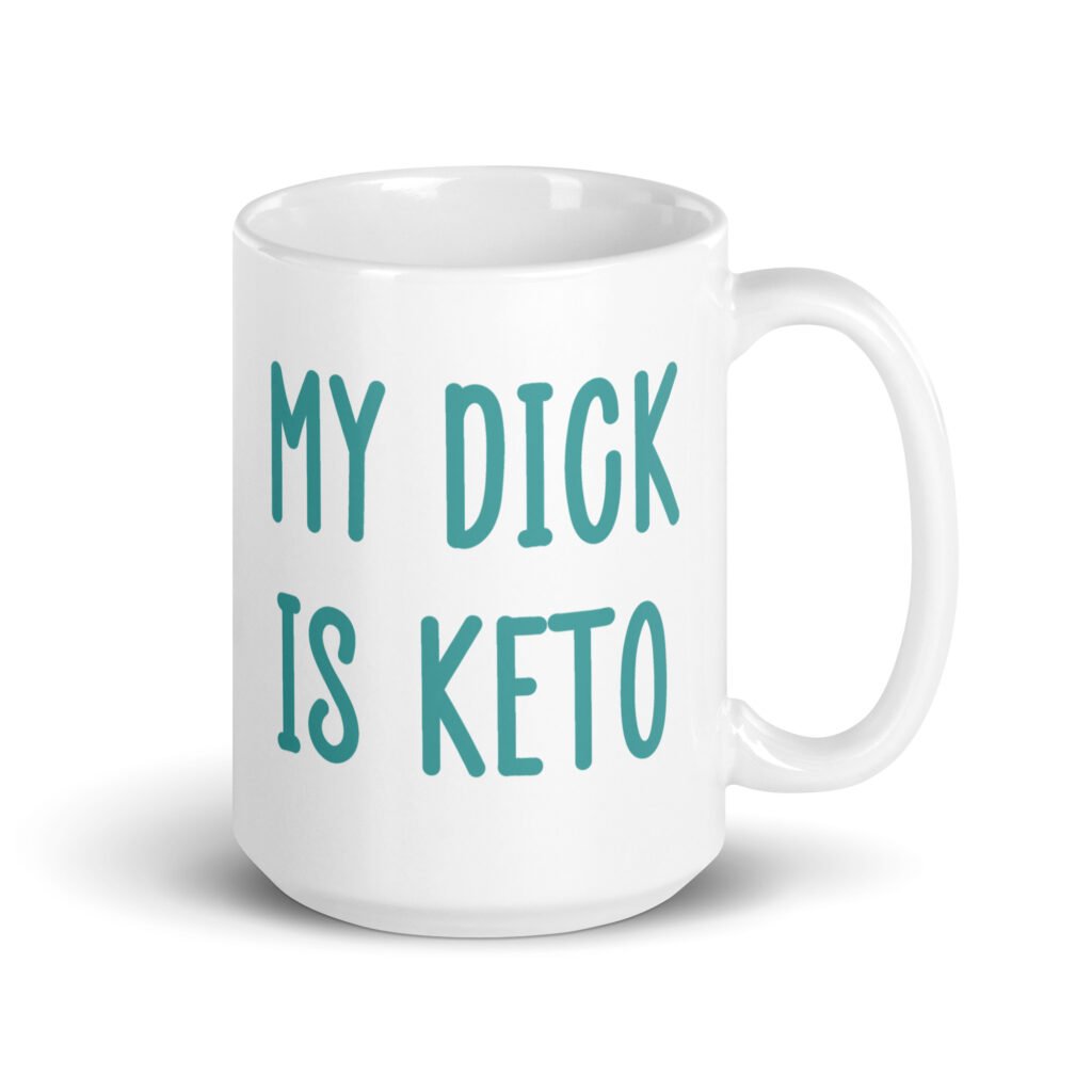 White ceramic coffee mug with the text 'My dick is keto' printed on both sides in turquoise font.
