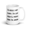 White ceramic mug with the text 'I'm really not funny. I'm just mean & people think I'm joking' printed on both sides.
