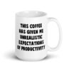 White ceramic coffee mug with the phrase 'This coffee has given me unrealistic expectations of productivity' printed on both sides.