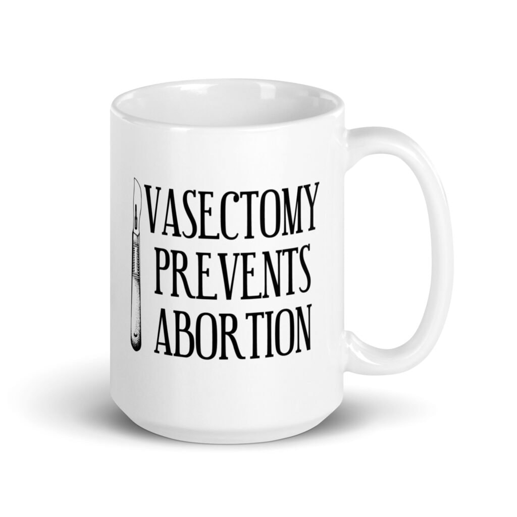 White ceramic coffee mug that has an image of a surgical scalpel and the phrase 'Vasectomy prevents abortion' printed on both sides.