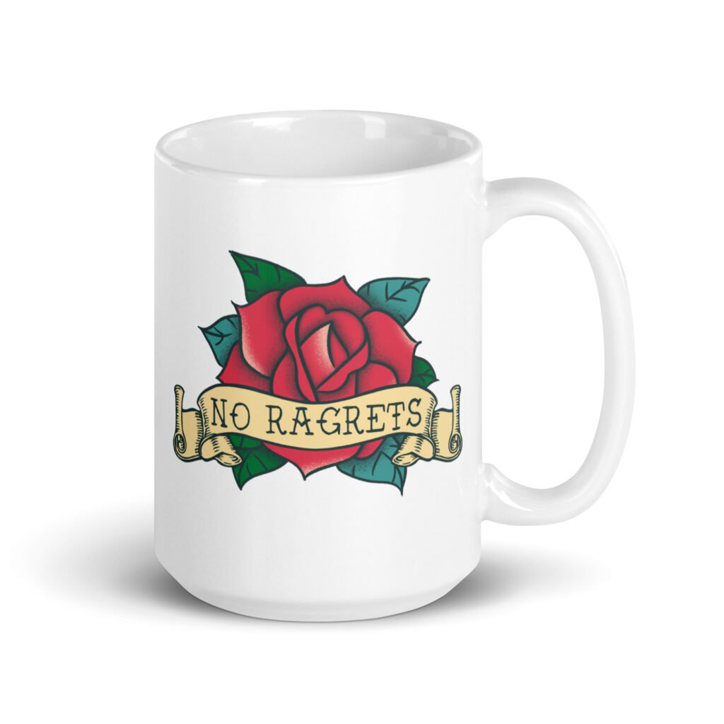 White ceramic coffee mug with funny image of an old school rose flash tattoo with the words 'No ragrets' intentionally misspelled. The graphics are printed on both sides of the mug.