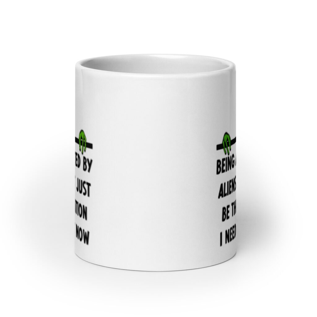 White ceramic mug with image of an alien and the words 'Being abducted by aliens might just be the vacation I need right now' printed on both sides.