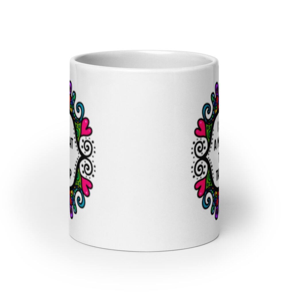 White ceramic mug with a colorful doodle graphic and the words 'I support a man's right to shut the hell up.' The design is printed on both sides of the mug.