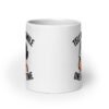 White ceramic mug with graphic of a woman holding a knife and the phrase 'Tell me to smile one more time' printed on both sides.