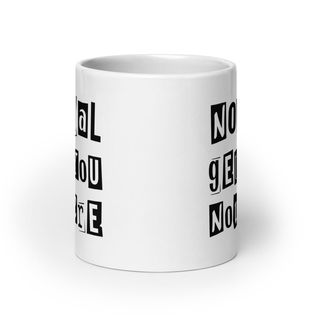 White ceramic coffee mug with the phrase 'Normal gets you nowhere' printed on both sides.
