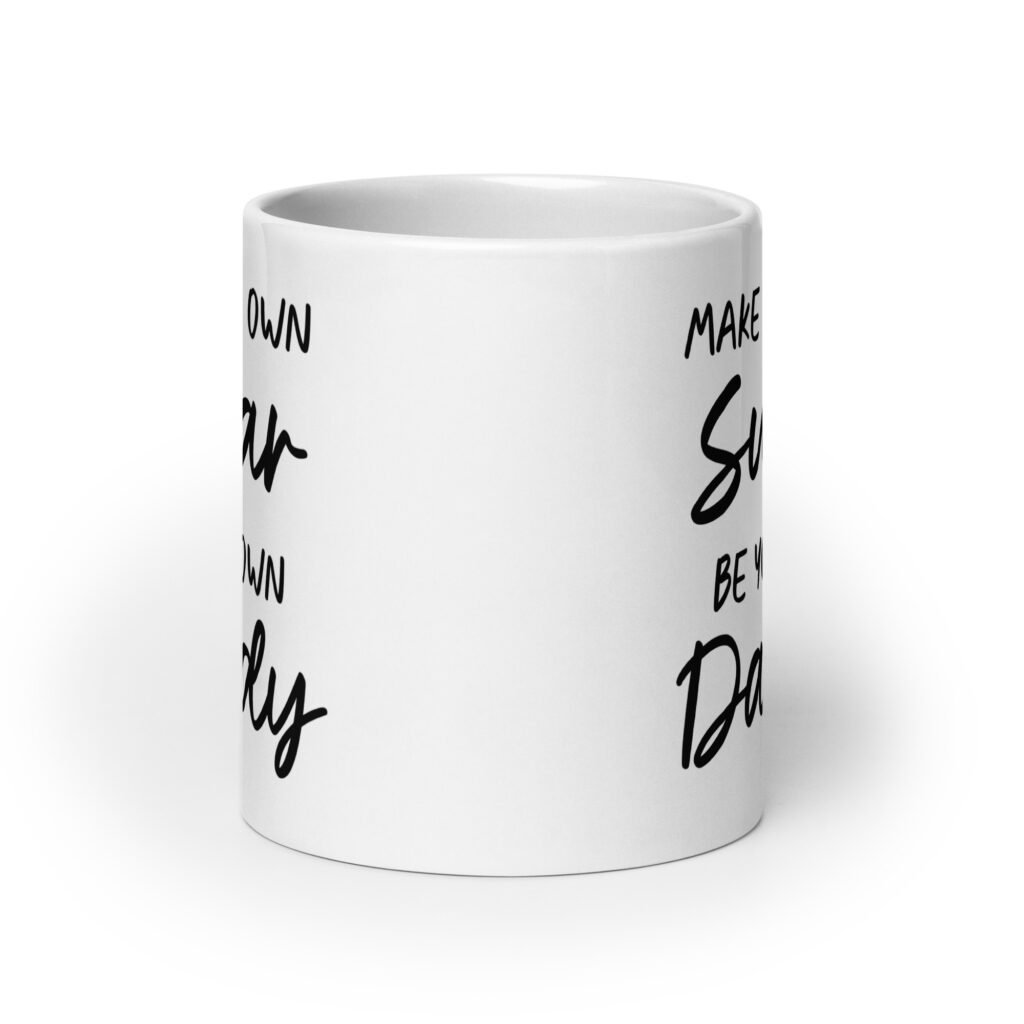 White ceramic coffee mug with the text 'Make your own sugar Be your own Daddy' printed on both sides.