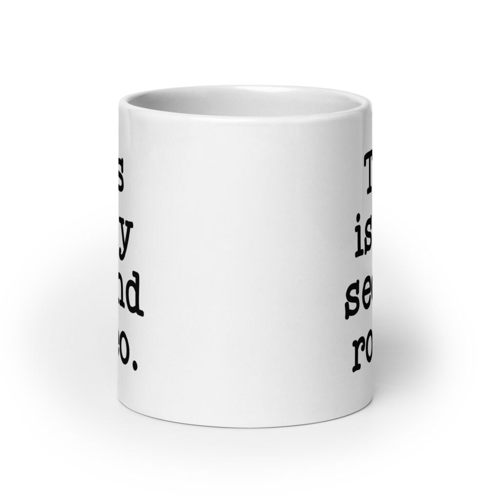 White ceramic mug with the text 'This is my second rodeo.' printed on both sides of the mug.