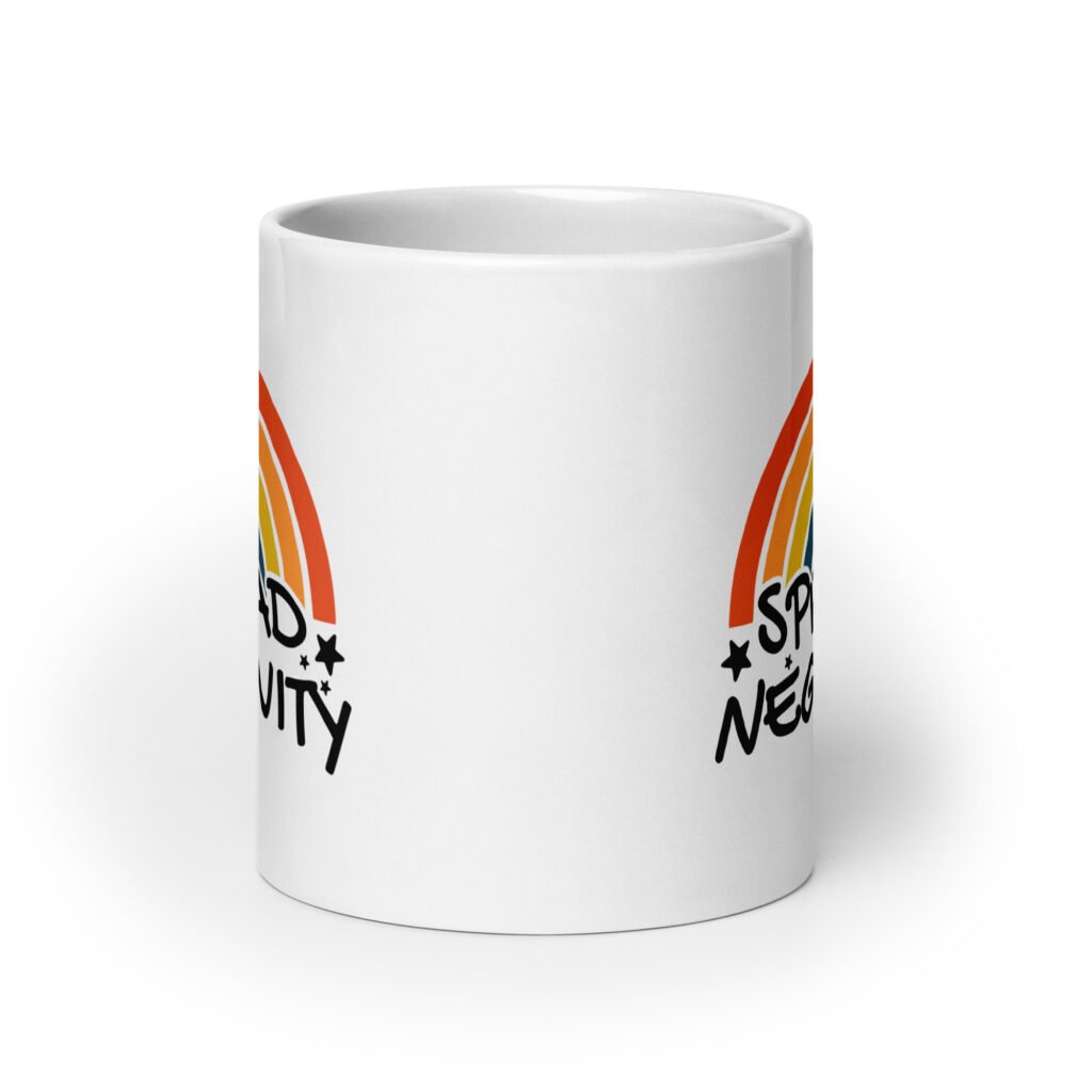 White ceramic coffee mug with a graphic of a rainbow and the words 'Spread negativity' printed on both sides.