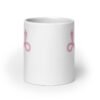 White ceramic coffee mug with with image of a pink uterus flipping middle finger graphic printed on both sides.