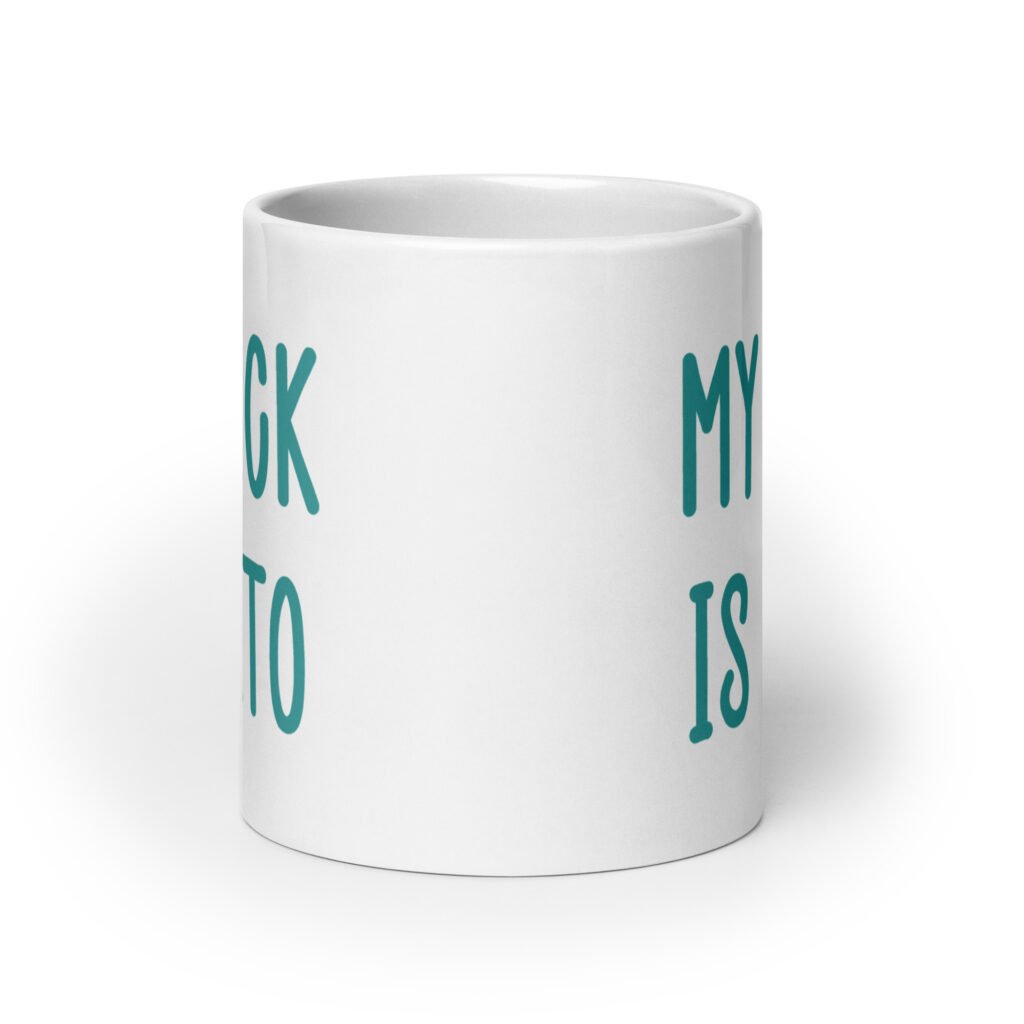 White ceramic coffee mug with the text 'My dick is keto' printed on both sides in turquoise font.