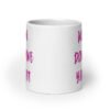 White ceramic coffee mug with the words 'Women don't owe you shit' printed on both sides in pink.