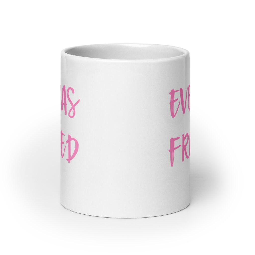 White ceramic coffee mug with the text 'Eve was framed' printed on both sides in pink.