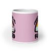Pink and white ceramic coffee mug with a graphic of a kawaii style unicorn and a pastel rainbow with the text 'Everything is fucked' printed on both sides. The background is pink.