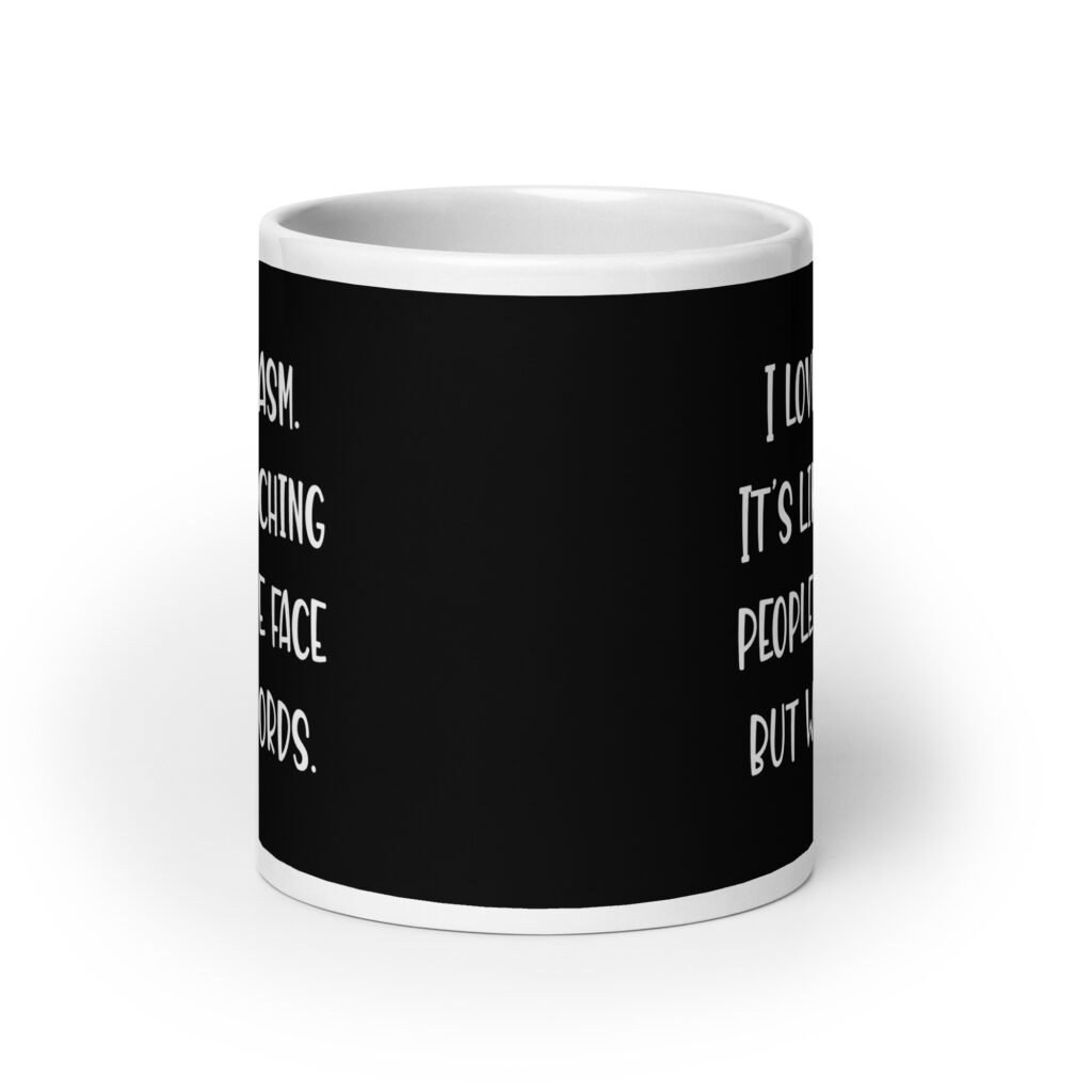 Black and white coffee mug with the text 'I love sarcasm. It's like punching people in the face but with words' printed on both sides.
