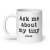White ceramic mug with the text 'Ask me about my tiny penis' printed on both sides. The word tiny is much smaller than the rest of the text.