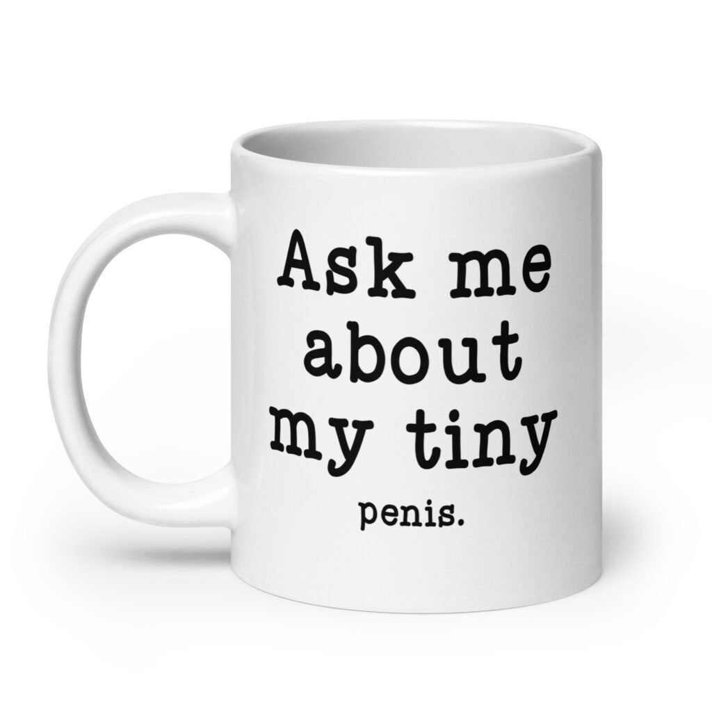 White ceramic mug with the text 'Ask me about my tiny penis' printed on both sides. The word tiny is much smaller than the rest of the text.