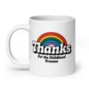 White ceramic mug with an image of a rainbow and the words 'Thanks for the childhood trauma' printed on both sides. The word Thanks is large and the rest of the words are smaller under.