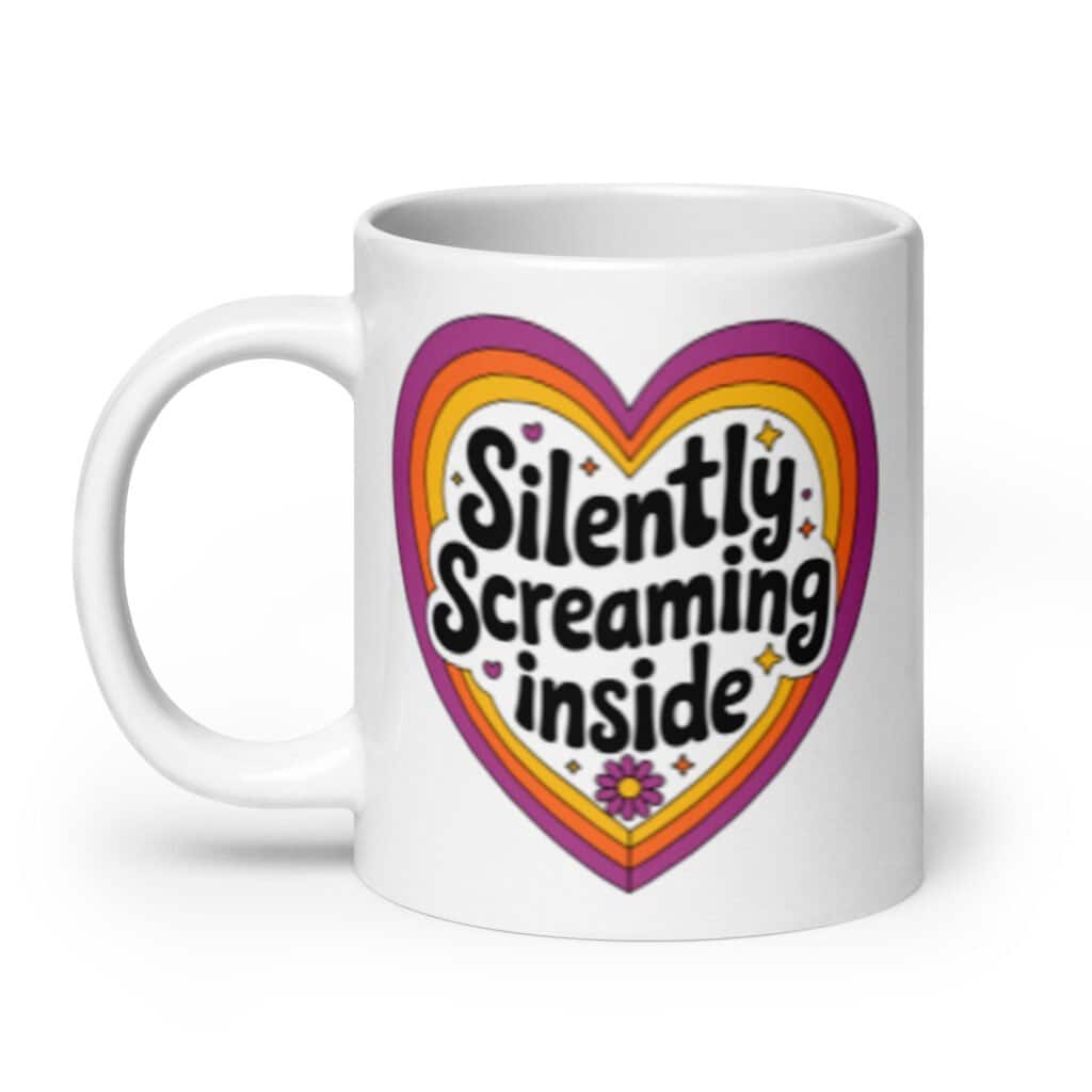 White ceramic coffee mug with a colorful graphic that says 'Silently screaming inside'. The graphics are printed on both sides of the mug.
