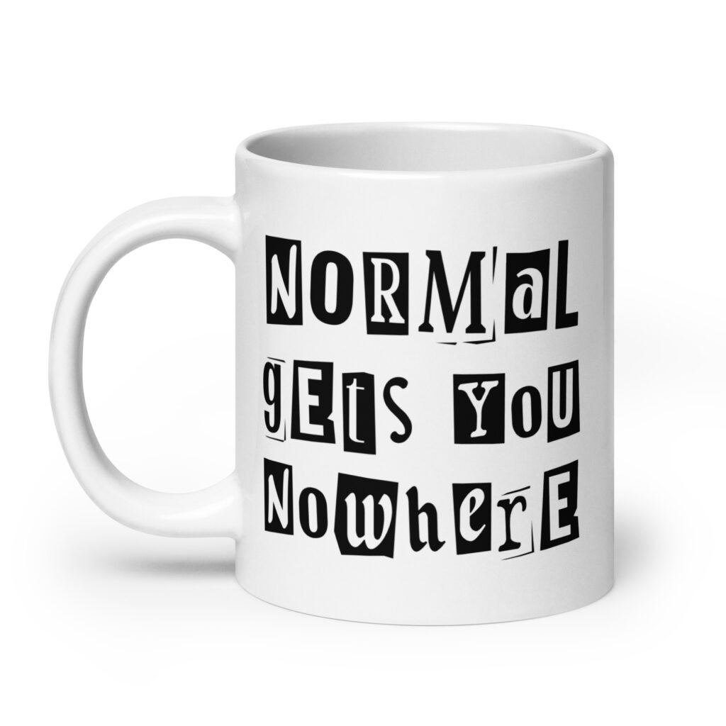 White ceramic coffee mug with the phrase 'Normal gets you nowhere' printed on both sides.