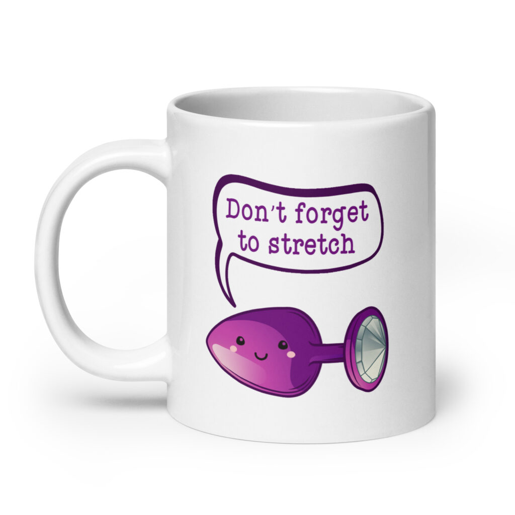 White ceramic coffee mug that has image of a purple anal plug with a smile face. There is a speech bubble above with the words 'Don't forget to stretch'. The graphics are printed on both sides of the mug.