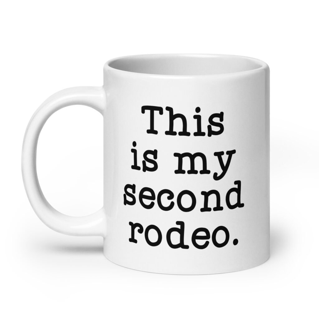 White ceramic mug with the text 'This is my second rodeo.' printed on both sides of the mug.
