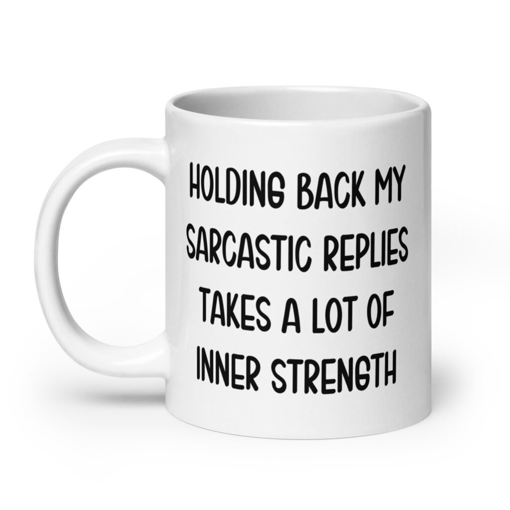 White ceramic mug with the phrase 'Holding back my sarcastic replies takes a lot of inner strength' printed on both sides of the mug.