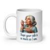 White ceramic coffee mug with an image of grey haired older woman enjoying a bite of a piece of cake with the words 'I hope your cake is as moist as I am' printed on both sides.