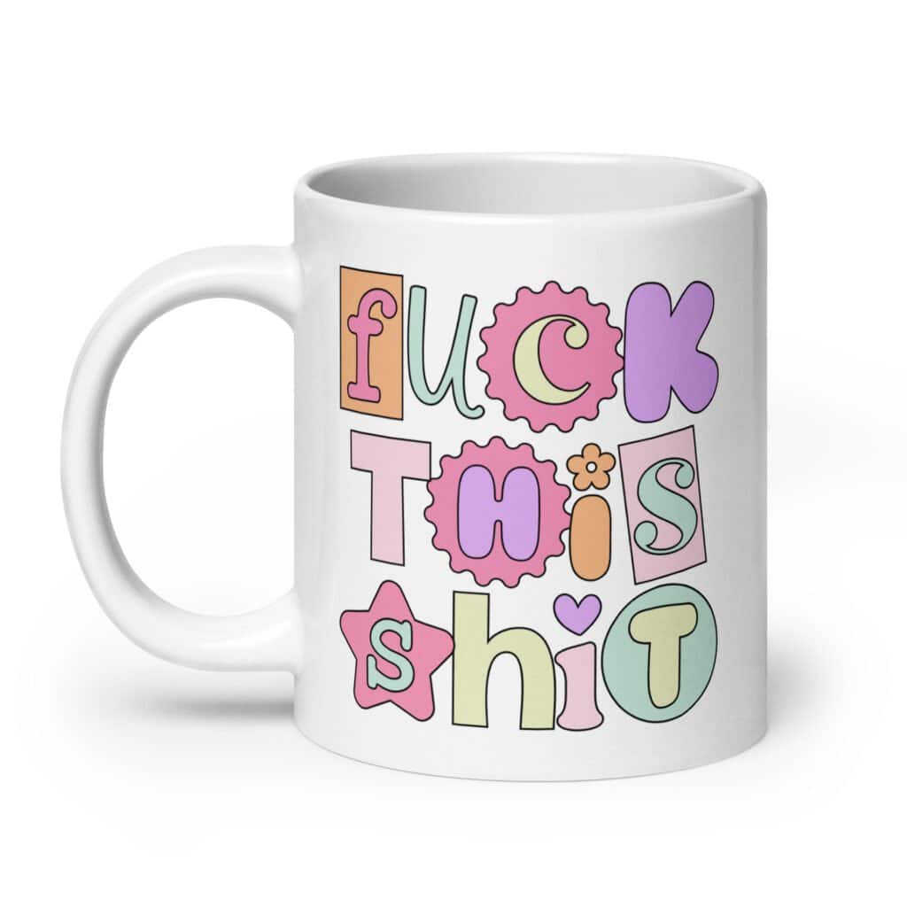 White ceramic coffee mug with colorful pastel font 'Fuck this shit' graphics printed on both sides.
