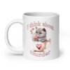 White ceramic mug that says 'I think about murder' with image of cute fluffy kitten sitting in a teacup printed on both sides.