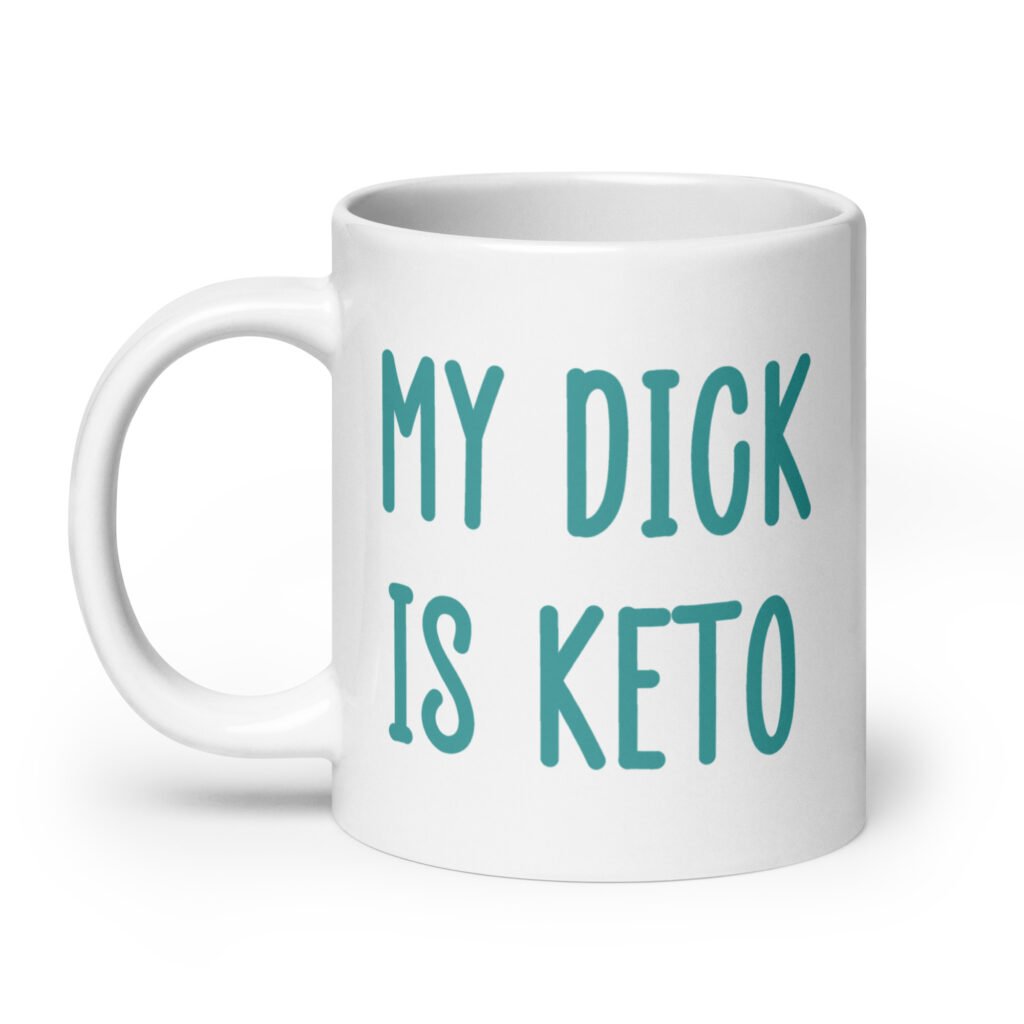 White ceramic coffee mug with the text 'My dick is keto' printed on both sides in turquoise font.