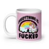 Pink and white ceramic coffee mug with a graphic of a kawaii style unicorn and a pastel rainbow with the text 'Everything is fucked' printed on both sides. The background is pink.