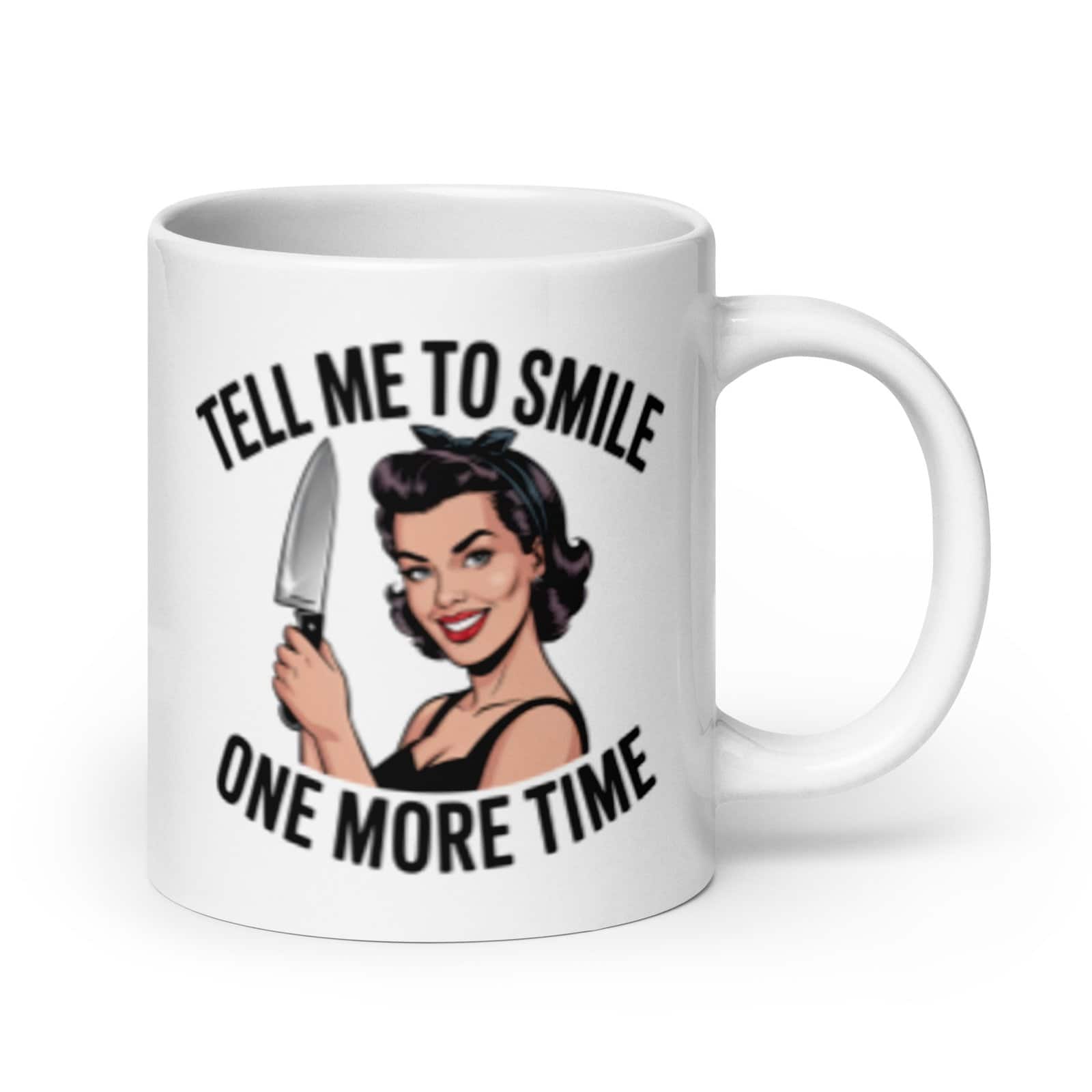 White ceramic mug with graphic of a woman holding a knife and the phrase 'Tell me to smile one more time' printed on both sides.